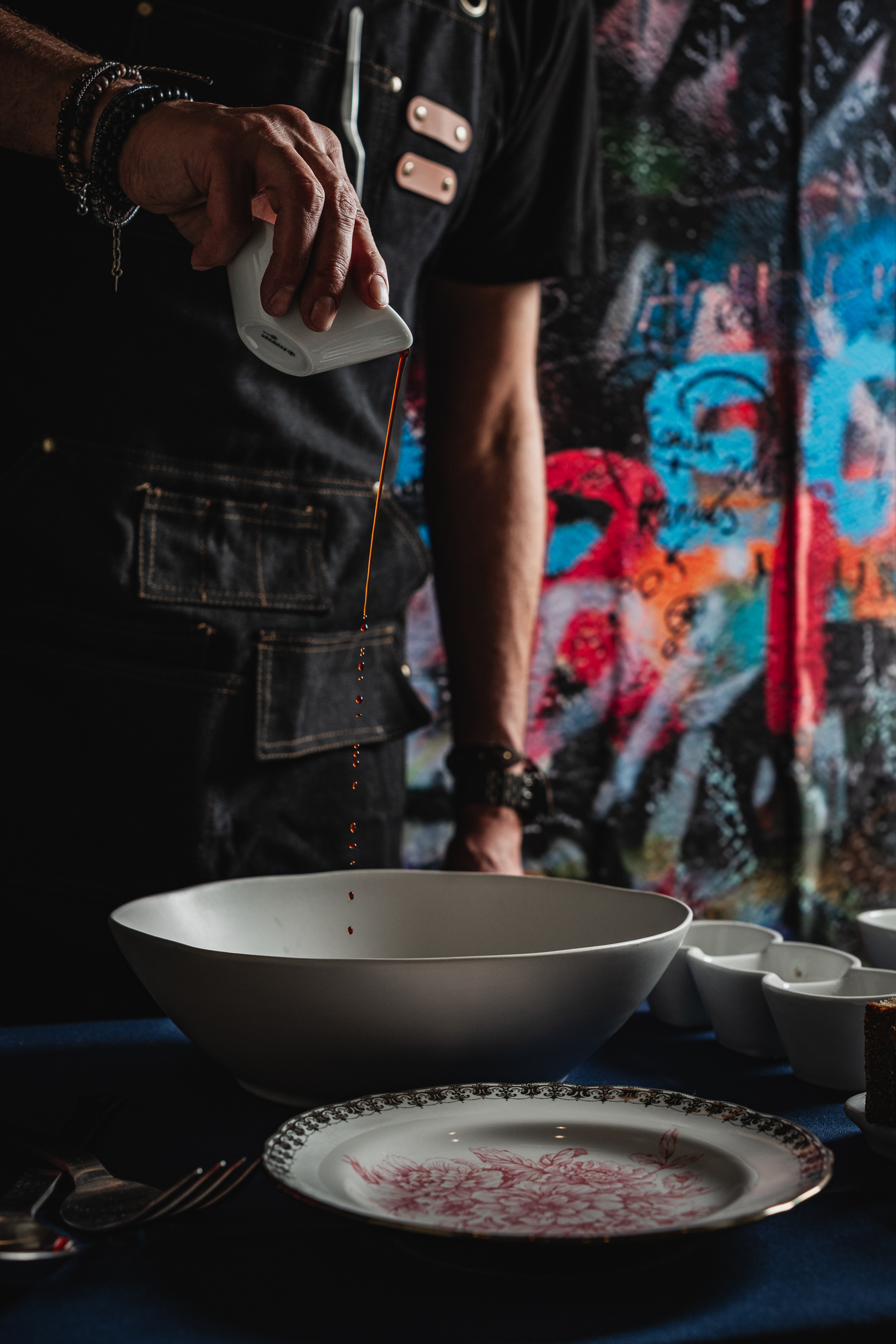 Hayworth chef pouring sauce into bowl — Henderson Nevada restaurant kitchen craft and precision
